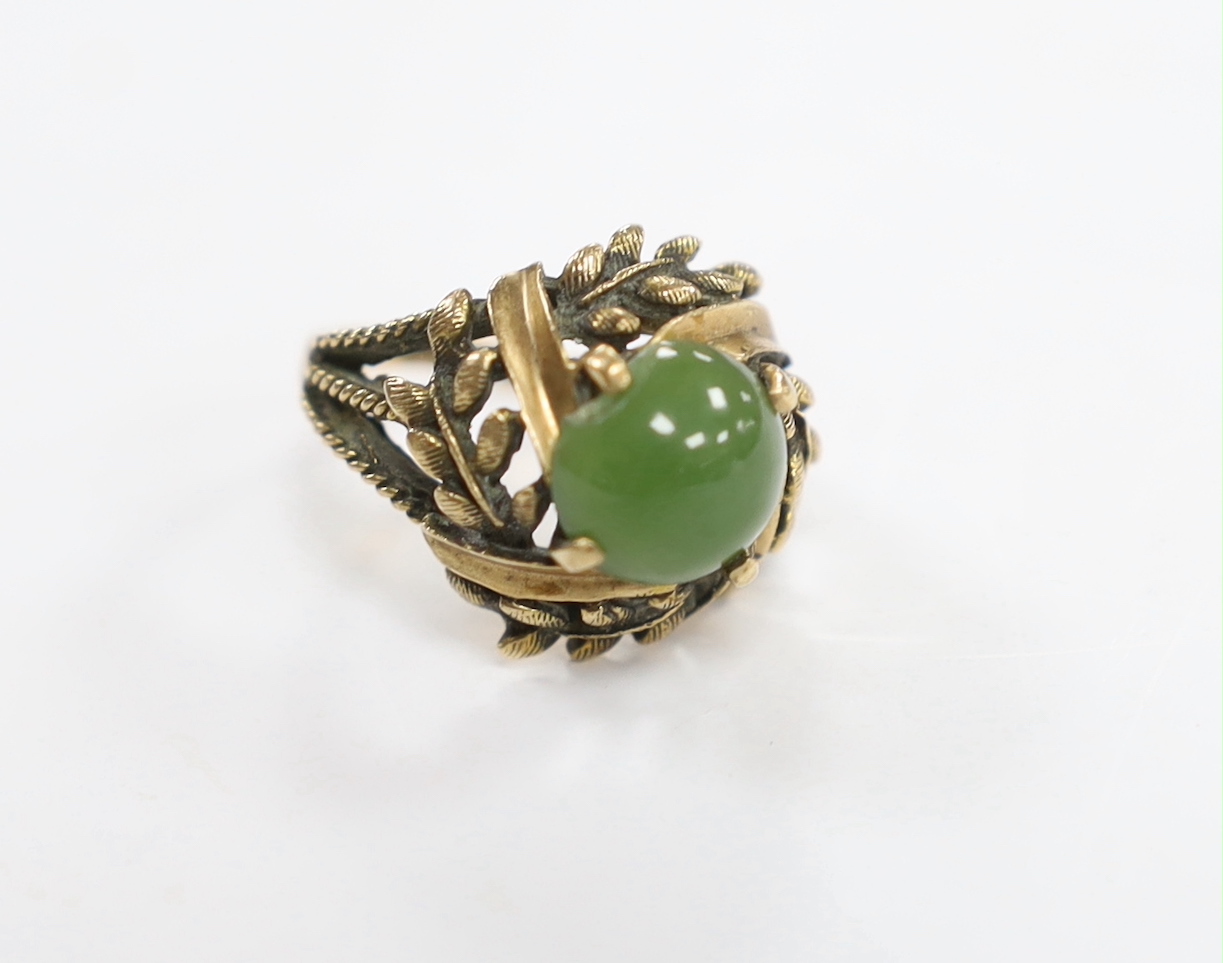A 10k and oval cabochon jade set dress ring, size L, gross weight 6.2 grams.